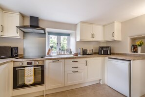 A modern kitchen with white cabinetry, a built-in oven, a microwave, and a dishwasher. - 2 Bed in Appersett (oc-d45772) (Appersett)