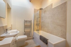A modern bathroom with a bathtub, a glass shower enclosure, and a white sink. - 2 Bed in Cockermouth (oc-b44967) (Cockermouth)