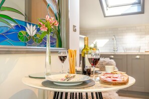 A dining table with a meal, wine glasses, and a bottle of wine in a modern kitchen setting. - 1 Bed in Sibsey (oc-s45757) (Sibsey)
