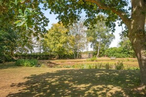 A park with a pond, trees, and a bench. - 1 Bed in Sibsey (oc-s45757) (Sibsey)