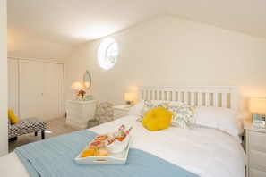 A bedroom with a bed, bedside tables, a dresser, a chair, a window, and a tray with food. - 1 Bed in Sibsey (oc-s45757) (Sibsey)