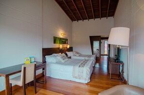 A hotel room with two beds, a desk, a chair, a lamp, and a television. - Hotel Piedras Blancas (San Felipe)