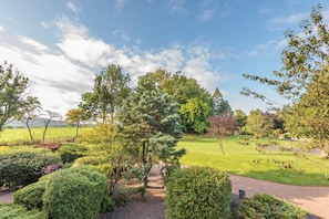 A landscaped garden with a variety of trees and shrubs, a paved walkway, and a well-maintained lawn. - 1 Bed in Berrier (oc-g45742) (Hutton)