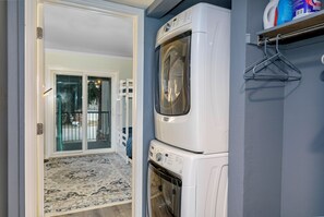 A laundry room with a front-loading washer and dryer, a hanging rack, and a door leading to a balcony. - Great location. Your Beaver Creek + Vail Basecamp (Avon)