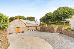 A stone building with a gravel driveway leading to a wooden gate. - 3 Bed in Challacombe (oc-s45342) (Challacombe)