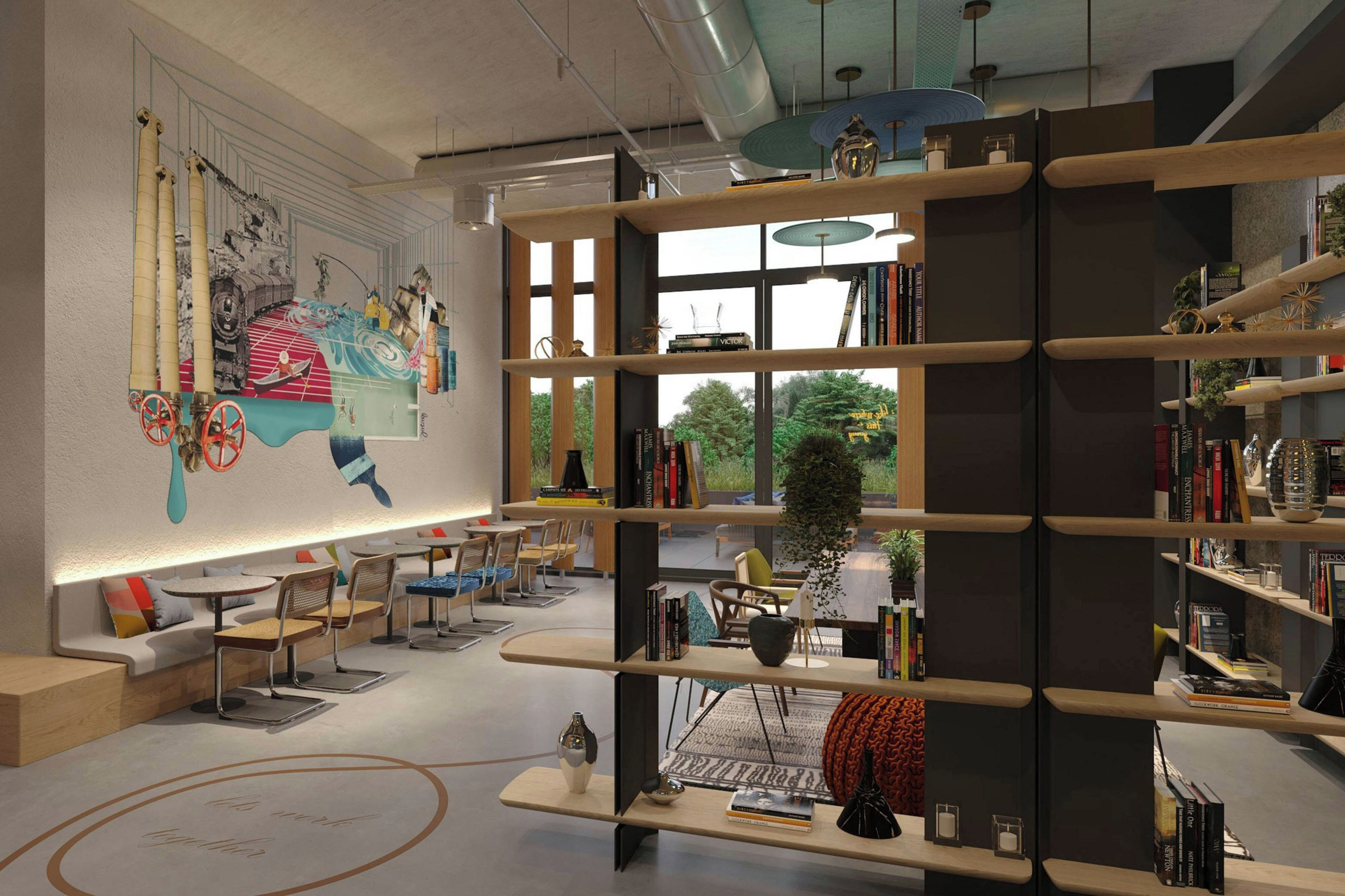 Una biblioteca moderna con estanterías, zonas de estar y un mural en la pared.