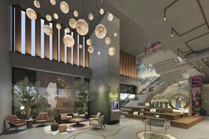 A modern interior with a seating area, a gaming zone, and a staircase.