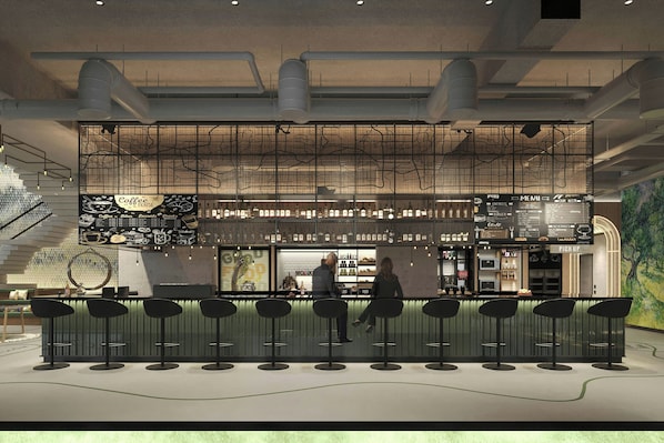 A modern bar area with a high ceiling, exposed ductwork, and a menu board.