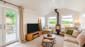 A cozy living room with a television, a fireplace, a sofa, and a coffee table. - 2 Bed in Kirkby-in-Furness (oc-s42634) (Kirkby Ireleth)