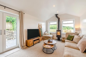 A cozy living room with a television, a fireplace, a sofa, and a coffee table. - 2 Bed in Kirkby-in-Furness (oc-s42634) (Kirkby Ireleth)