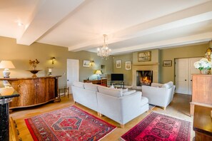 A living room with a fireplace, sofas, a television, and a decorative cabinet. - 4 Bed in Wensley (oc-t45784) (Wensley)