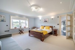 A bedroom with a large bed, bedside tables, a window, and a door leading to another room. - 4 Bed in Wharton (oc-h45870) (Wharton)