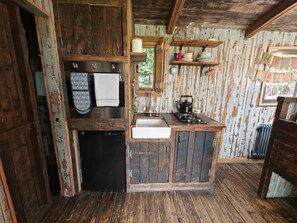 A rustic kitchen with wooden cabinets, a sink, a stove, and a refrigerator. - 2 Bed in Earsdon (oc-s45692) (Earsdon)
