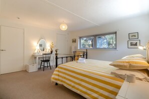 A bedroom with a bed, a desk, a chair, a window, and a door. - 4 Bed in Beccles (oc-b45848) (Beccles)