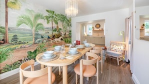 A dining area with a mural, a chandelier, and a view into the kitchen. - 3 Bed in Rock (oc-r45594) (Rock)