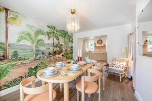 A dining area with a mural, a chandelier, and a view into the kitchen. - 3 Bed in Rock (oc-r45594) (Rock)