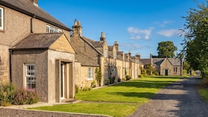 A row of traditional stone houses with a gravel driveway and well-maintained lawns. - 3 Bed in Rock (oc-r45594) (Rock)