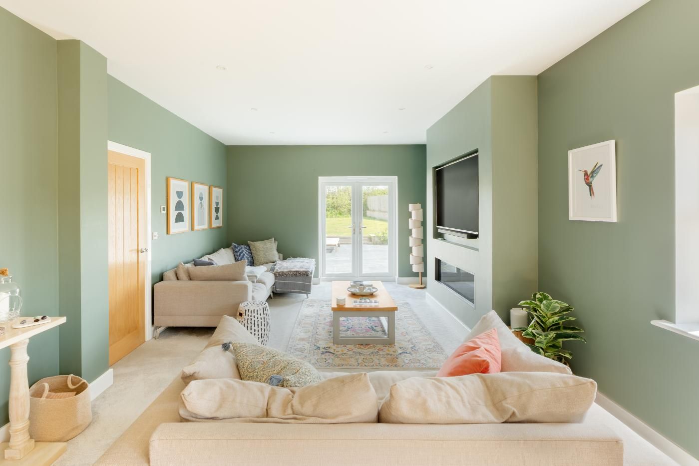 A living room with a sofa, coffee table, and a television.
