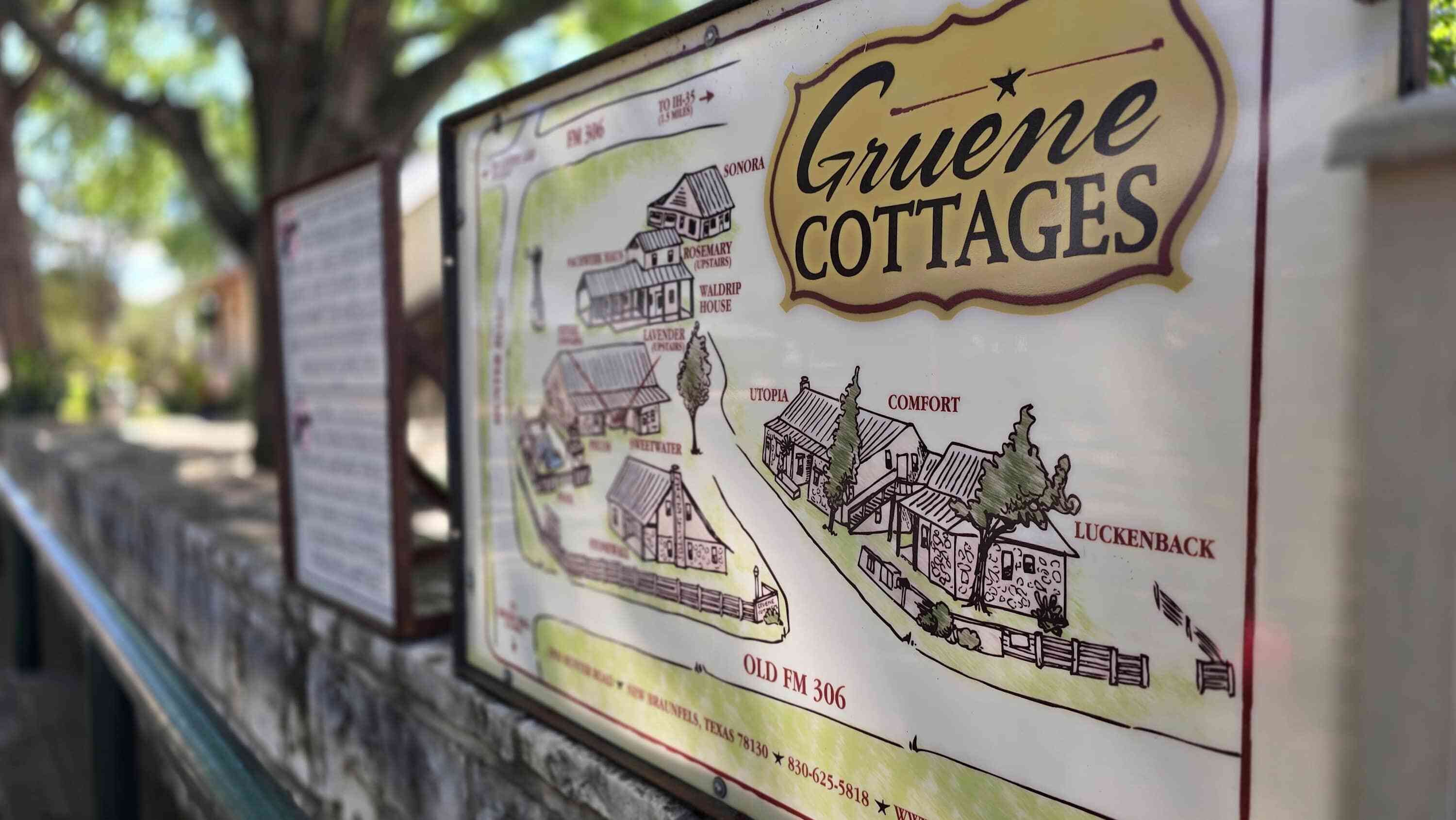 A sign for Gruene Cottages with illustrations of the property layout, including labeled cottages like Comfort and Luckenback.