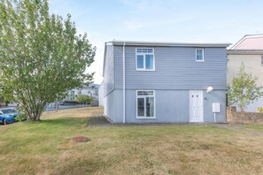 A two-story residential building with a front door, windows, and a small yard. - 4 Bed in Newquay (oc-a45834) (Black Cross)