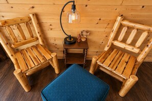 Two wooden chairs with a small table and a lamp between them. - Waterfront Cabin - Private Dock, Kayaks, ATV & Snowmobile Trails (Bigfork)
