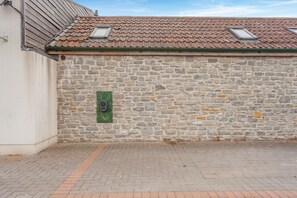 A stone wall with a green door and a window. - 2 Bed in Evercreech (oc-t40223) (Evercreech)