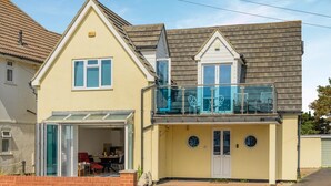 A two-story house with a balcony, a garage, and a visible kitchen area. - 2 Bed in Bournemouth (oc-f45847) (Bournemouth)