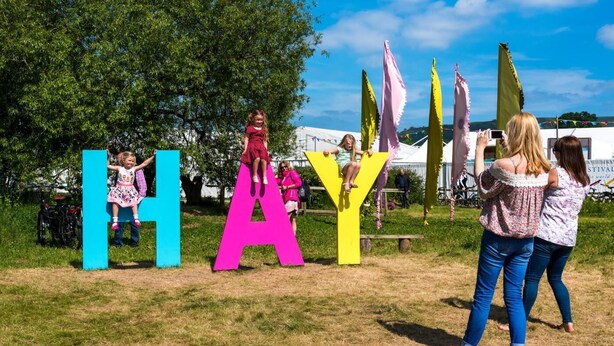 A grassy outdoor area with large colorful letters spelling 'HAY' and a bicycle parked nearby. - 1 Bed in Hay-on-Wye (oc-s45846) (Hay-on-Wye)
