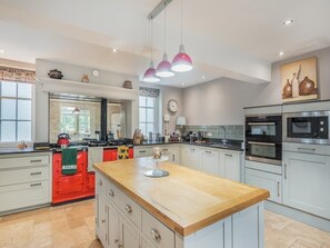 A modern kitchen with a central island, stainless steel appliances, and pendant lighting. - 5 Bed in Burton Pedwardine (oc-g42735) (Burton Pedwardine)