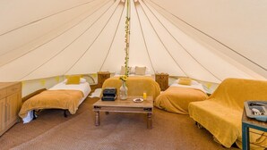 A tent with two beds, a table with a vase, and a chair. - 1 Bed in St. Florence (oc-s33553) (Saint Florence)