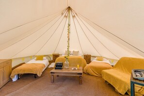 A tent with two beds, a table with a vase, and a chair. - 1 Bed in St. Florence (oc-s33553) (Saint Florence)
