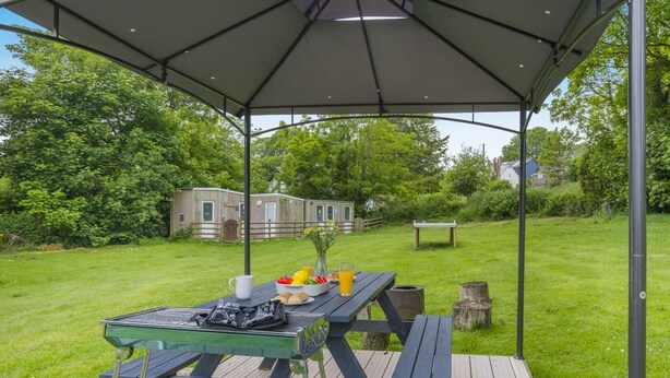 An outdoor dining area with a table set for two, a picnic table, and a covered seating area. - 1 Bed in St. Florence (oc-s33553) (Saint Florence)