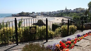 A coastal view with a beach, promenade, and buildings in the background. - 1 Bed in St. Florence (oc-s33553) (Saint Florence)