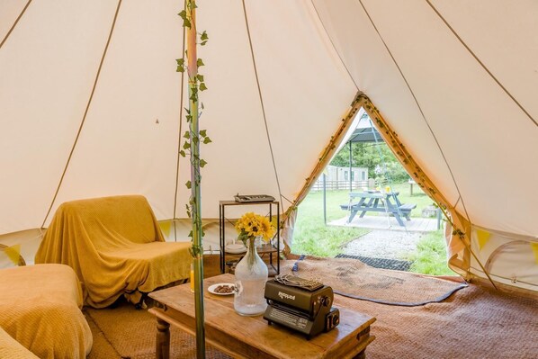 A tent with a table, a chair, and a view of an outdoor picnic area. - 1 Bed in St. Florence (oc-s33553) (Saint Florence)