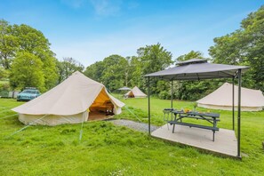 A campsite with tents, a picnic table, and a car parked nearby. - 1 Bed in St. Florence (oc-s33553) (Saint Florence)