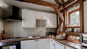 A modern kitchen with white cabinets, a gas stove, and a built-in oven. - 2 Bed in Brighton (oc-80378) (Poynings)