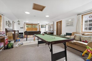 A room with a pool table, a sofa, and a window with curtains. - 1 Bed in Milton Abbas (oc-a35016) (Milton Abbas)