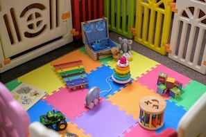 A play area with a mat, toys, and a toy chest. - 1 Bed in Milton Abbas (oc-c35017) (Milton Abbas)