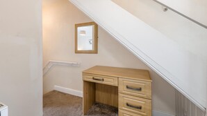 A room with a wooden desk, a mirror, and a carpeted floor. - 3 Bed in Whitby (oc-c40269) (Whitby)