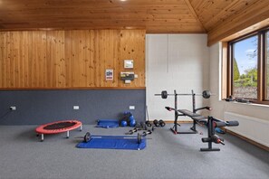A gym with a trampoline, weightlifting equipment, and a window with a view. - 1 Bed in Milton Abbas (oc-l35018) (Milton Abbas)