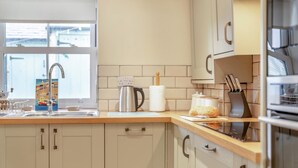 A modern kitchen with a sink, kettle, and bread on the counter. - 2 Bed in Whitby (oc-m32879) (Whitby)