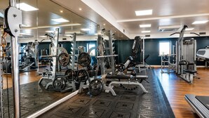 A gym with various exercise equipment, a mirrored wall, and a patterned floor. - 1 Bed in Barnham Broom (oc-p42617) (Barnham Broom)