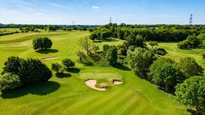 A golf course with sand bunkers, trees, and a clear sky. - 2 Bed in Barnham Broom (oc-s42613) (Barnham Broom)