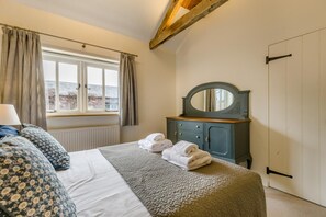 A bedroom with a bed, a dresser, a window with curtains, and a door. - 3 Bed in Cranmer (oc-s45787) (Cranmer)
