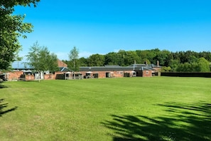 A large, open grassy field with a brick building in the background. - 2 Bed in Cranmer (oc-o45790) (Cranmer)