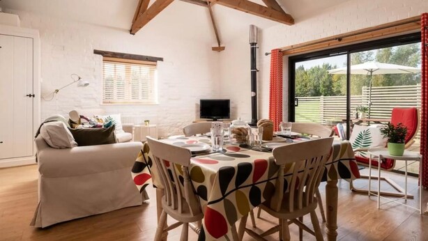 A cozy room with a dining table, chairs, a sofa, a TV, and a view of the outdoors. - 2 Bed in Cranmer (oc-w45791) (Cranmer)