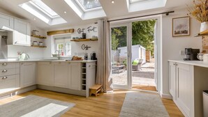 A modern kitchen with skylights, a coffee station, and a view of the backyard. - 2 Bed in Great Massingham (oc-a45882) (Great Massingham)