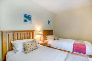 A hotel room with two single beds, a nightstand with a lamp, and a wall-mounted picture. - 2 Bed in Higher Eype (oc-d45830) (Eype)
