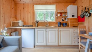 A compact kitchen with white cabinets, a sink, and a window. - 1 Bed in Laddingford (oc-s45860) (Laddingford)