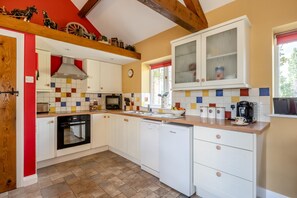 A kitchen with white cabinets, a tiled backsplash, a coffee maker, and a window with a red blind. - 1 Bed in Boys Hill (oc-b45932) (Boys Hill)